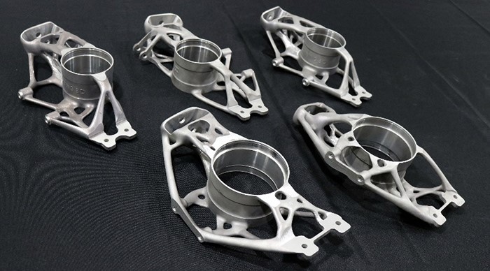 A set of five 3D printed aluminium suspension upright carriers for a Formula Student car