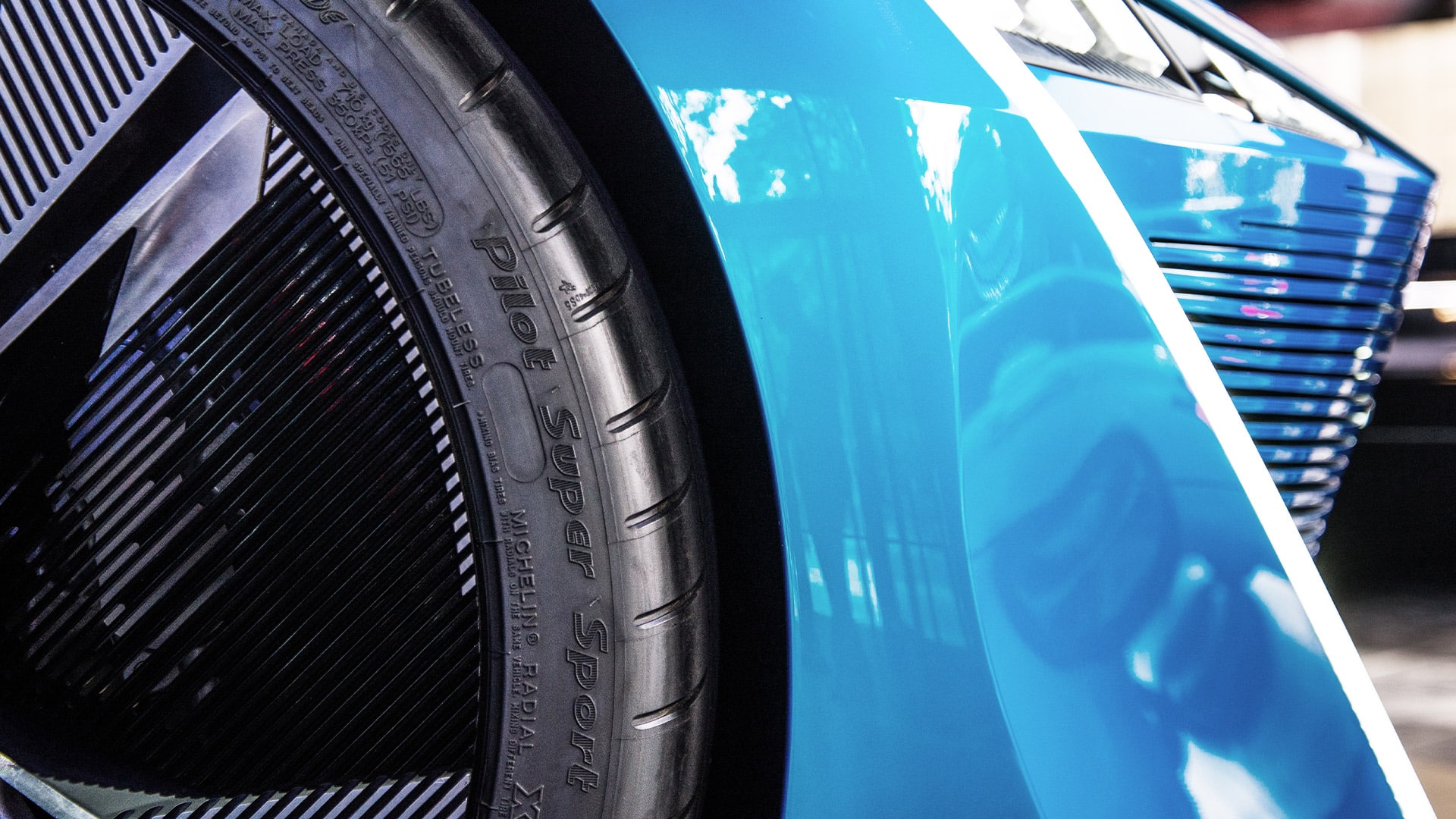 Detail of a car's 3D printed grille and wheel, an example of automotive applications for additive manufacturing